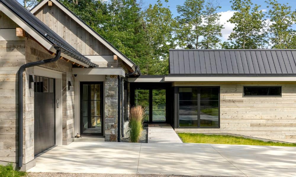 Modern rustic home with a sleek metal roof and natural wood siding.