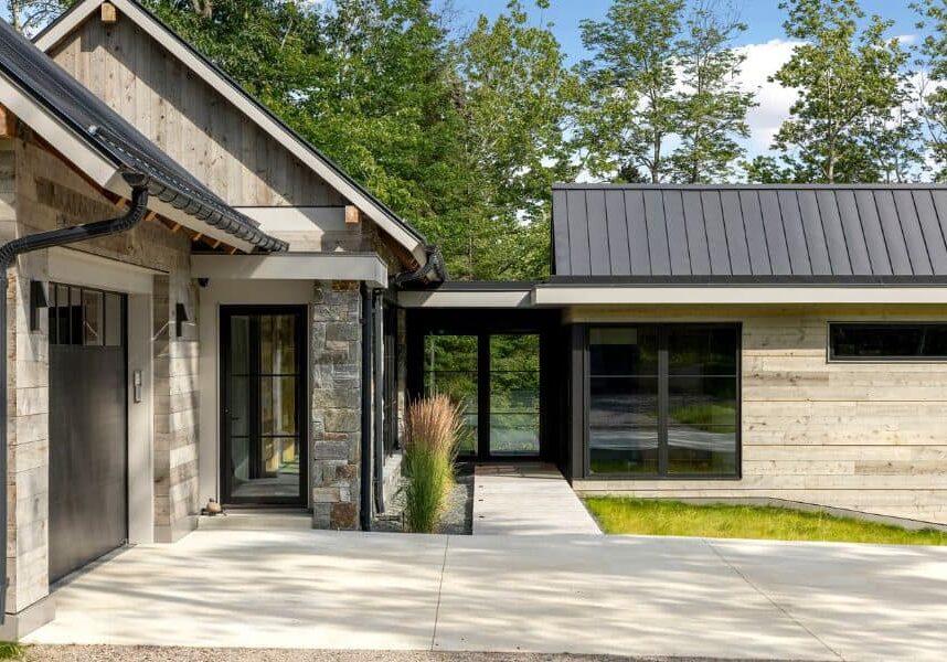 Modern rustic home with a sleek metal roof and natural wood siding.